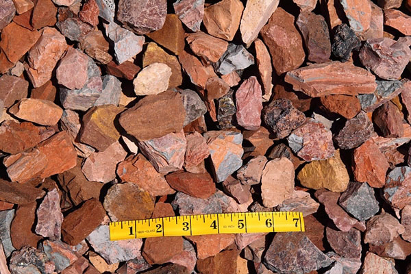 Multicolored Decorative rock with a measuring tape to show scale